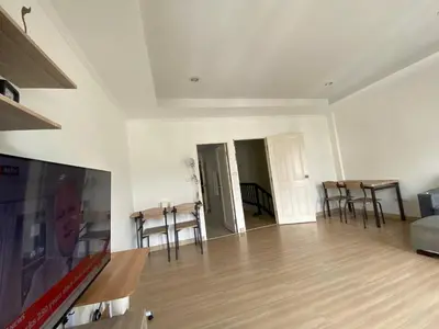 a living room with a flat screen tv and chairs at Superb Apartment in Ban Na Khua