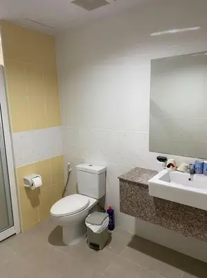 a bathroom with a toilet and a sink at Superb Apartment in Ban Na Khua