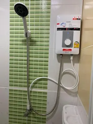 a shower in a bathroom with a toilet and a shower at Superb Apartment in Ban Na Khua
