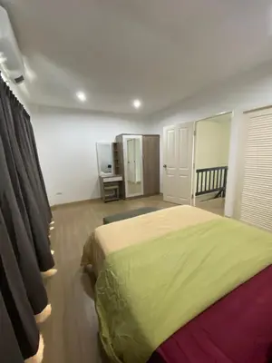 a bedroom with a large bed in a room at Superb Apartment in Ban Na Khua