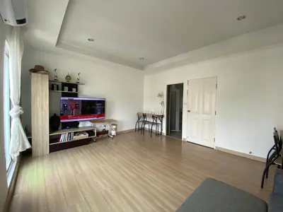 an empty living room with a flat screen tv at Superb Apartment in Ban Na Khua