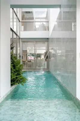 a swimming pool in the middle of a building at \u90a6\u6d9b\uff08bangtao)\u82b1\u56ed\u6cf3\u6c60\u522b\u58853\u5367 in Ban Pak Lak
