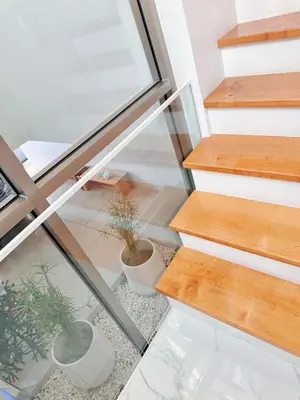 a glass staircase with potted plants on the floor at \u90a6\u6d9b\uff08bangtao)\u82b1\u56ed\u6cf3\u6c60\u522b\u58853\u5367 in Ban Pak Lak