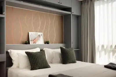 a bedroom with a large bed with white pillows at City Gate Kamala N303 by Phuket Sabay Rent in Phuket Town