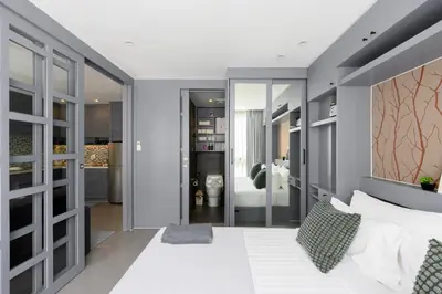 a bedroom with a white bed and a bathroom at City Gate Kamala N303 by Phuket Sabay Rent in Phuket Town