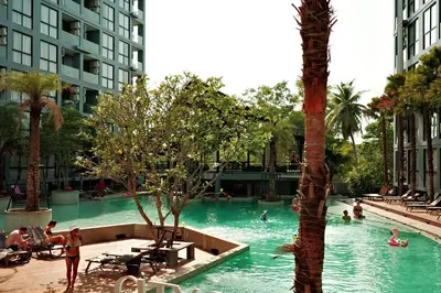 a swimming pool in a hotel with people in it at City Gate Kamala N303 by Phuket Sabay Rent in Phuket Town