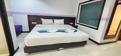 a bedroom with a large bed with two towels on it at Diamond Crown Hotel in Patong Beach