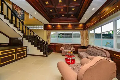 a living room filled with furniture and a staircase at Group Getaway Patong House in Patong Beach