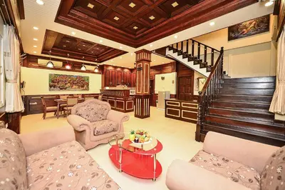 a living room with a couch and chairs and a table at Group Getaway Patong House in Patong Beach