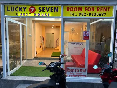 a scooter parked in front of a room for rent guest house at Lucky Seven Patong in Patong Beach