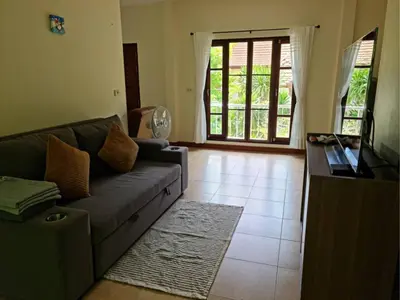 a living room with a couch and a television at Natures relax in Kamala Beach