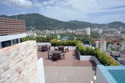 a patio with tables and chairs on top of a building at Sea view apartment at The Unity by Lofty in Patong Beach
