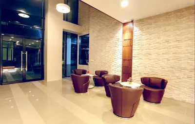 a lobby with chairs and a table in a building at Sea view apartment at The Unity by Lofty in Patong Beach