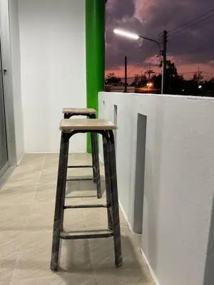 a stool sitting next to a white wall at Bangreen Naiyang Hotel in Nai Yang Beach