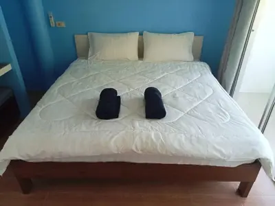 a pair of shoes sitting on a bed at Bangreen Naiyang Hotel in Nai Yang Beach