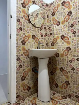 a bathroom with a sink and a mosaic wall at Bangreen Naiyang Hotel in Nai Yang Beach