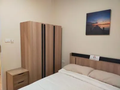 a bedroom with a bed and a wooden cabinet at Bonanza Patong Beach1 100m to Beach Moon Room in Patong Beach