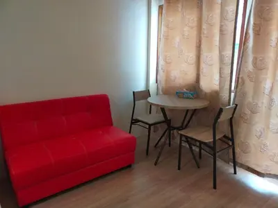 a living room with a red couch and a table at Bonanza Patong Beach1 100m to Beach Moon Room in Patong Beach