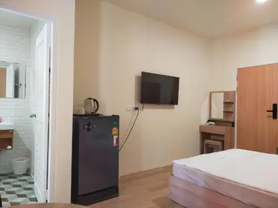 a room with a refrigerator and a tv on the wall at Bonanza Patong Beach1 100m to Beach Moon Room in Patong Beach