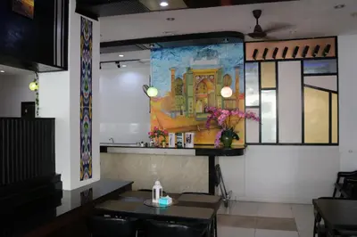 a dining room with tables and a painting on the wall at Diamond Crown in Patong Beach