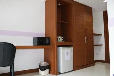 a kitchen with a cupboard and a refrigerator at Diamond Crown in Patong Beach