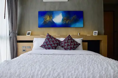 a bedroom with a bed with pillows on it at Villa Papaya @ Kamala Beach in Kamala Beach