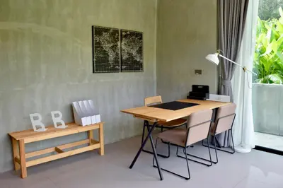 a desk and chairs in a room with a window at Villa Papaya @ Kamala Beach in Kamala Beach