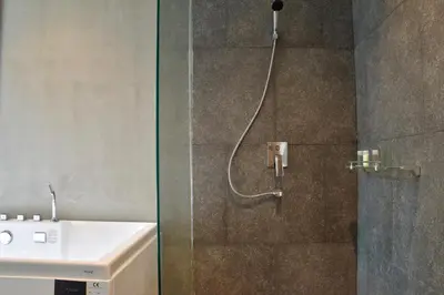 a bathroom with a shower with a sink and a shower head at Villa Papaya @ Kamala Beach in Kamala Beach