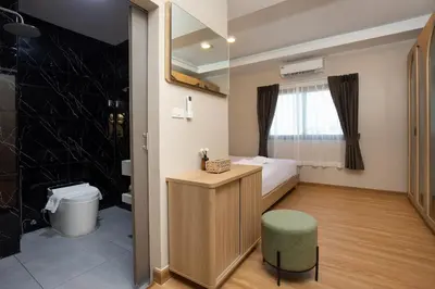 a small room with a bed and a bathroom at Tuna Boutique Hotel Patong in Patong Beach