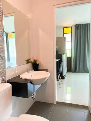 a bathroom with a sink and a tub and a toilet at Pim's Bed and Breakfast @ Phuket in Ban Bang Khu