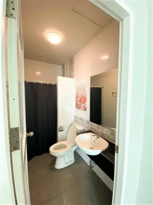 a bathroom with a toilet and a sink at Pim's Bed and Breakfast @ Phuket in Ban Bang Khu