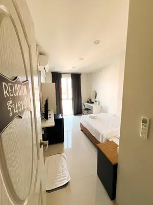 a hotel room with a bed and a sign on the door at Pim's Bed and Breakfast @ Phuket in Ban Bang Khu