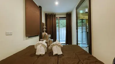 a bedroom with white shoes on a bed at Blackberry in Rawai Beach