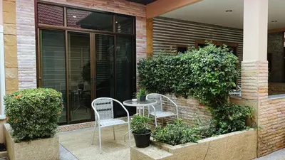 two chairs and a table in front of a building at Blackberry in Rawai Beach