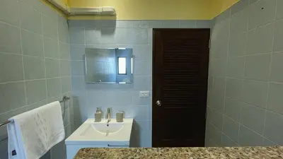 a bathroom with a sink and a mirror at Blackberry in Rawai Beach