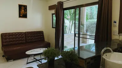 a living room with a couch and a table at Blackberry in Rawai Beach
