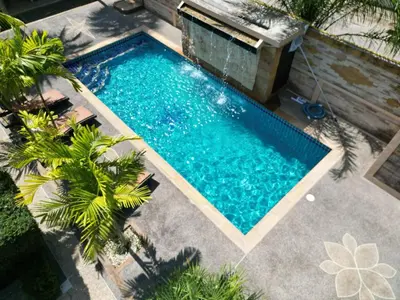 an overhead view of a swimming pool with palm trees at Blackberry in Rawai Beach