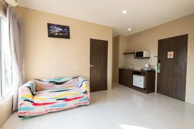 a room with a bed and a kitchen at Khao Rang Place in Phuket Town