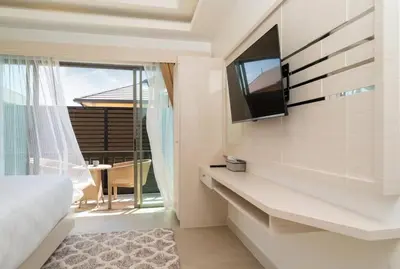 a bedroom with a bed and a tv on a wall at Pure Bliss Luxe 3BR Pool Villa Your Ultimate Tropical Getaway V29 V74 in Bang Tao Beach