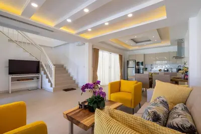 a living room with a couch and yellow chairs at Pure Bliss Luxe 3BR Pool Villa Your Ultimate Tropical Getaway V29 V74 in Bang Tao Beach