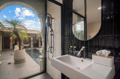 a bathroom with a sink and a mirror at Marococco Private Pool Villa in Ban Mut Dok Khao
