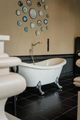 a bath tub in a bathroom with plates on the wall at Marococco Private Pool Villa in Ban Mut Dok Khao