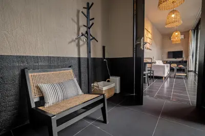 a room with a bench and a dining room at Marococco Private Pool Villa in Ban Mut Dok Khao