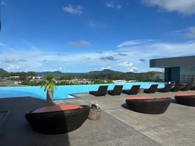 a patio with chairs and a swimming pool at Apartment in 5 hotel with sea view and waterpark in Rawai Beach
