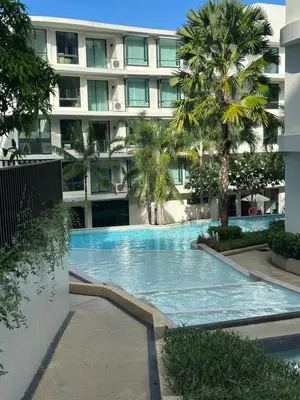 a swimming pool in front of a building at Apartment in 5 hotel with sea view and waterpark in Rawai Beach