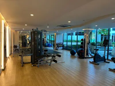 a gym with several treadmills and machines in a room at Apartment in 5 hotel with sea view and waterpark in Rawai Beach