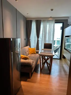 a living room with a couch and a table at Apartment in 5 hotel with sea view and waterpark in Rawai Beach