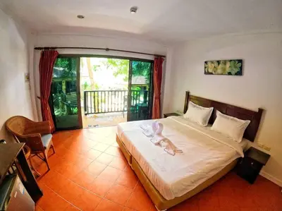 a bedroom with a large bed and a balcony at beautiful pool house in Patong Beach
