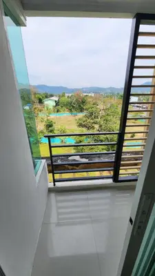 a room with a large window with a view at Plus condominium 2 kathu in Kathu