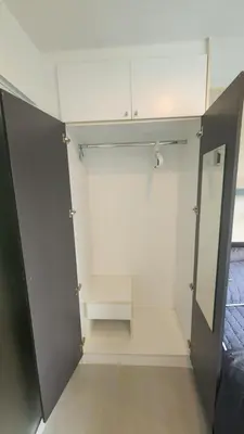 a walk in closet with a door and a mirror at Plus condominium 2 kathu in Kathu